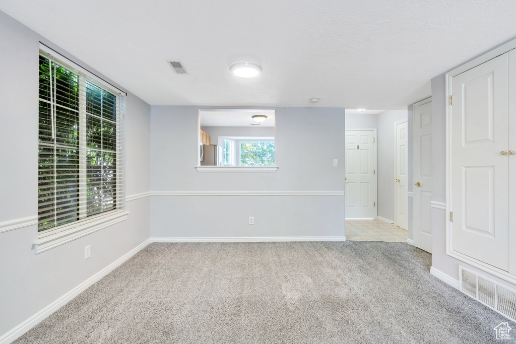 Carpeted spare room with baseboards