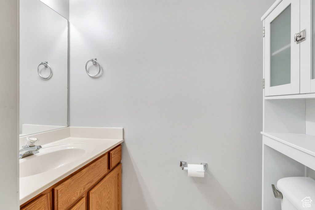 Half bathroom featuring toilet and vanity