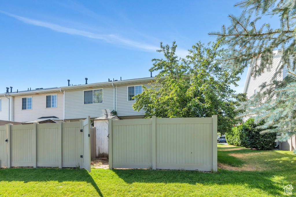 Rear view of property featuring a gate
