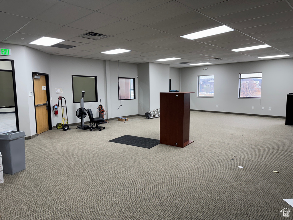 Misc room with light carpet and a paneled ceiling