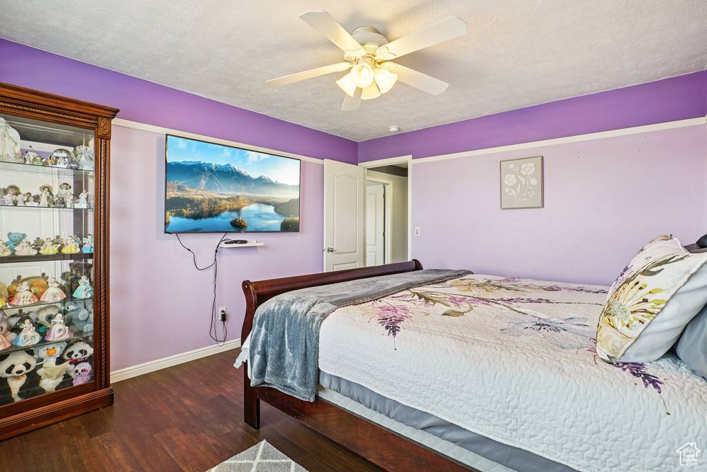 Bedroom with wood finished floors and a ceiling fan