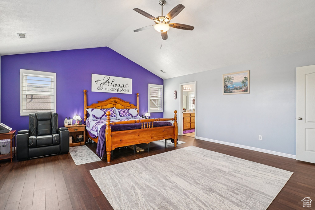 Bedroom featuring vaulted ceiling, dark wood-type flooring, ceiling fan, and connected bathroom