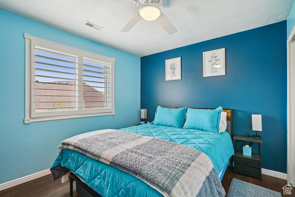 Bedroom with wood finished floors and ceiling fan