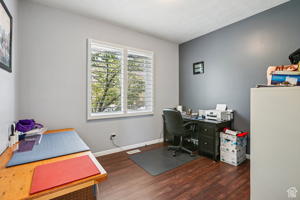 Office space with wood finished floors and baseboards