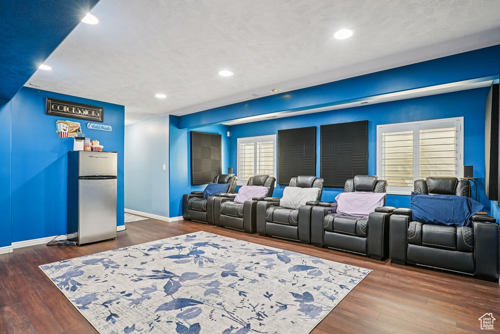 Cinema featuring dark wood-type flooring and recessed lighting