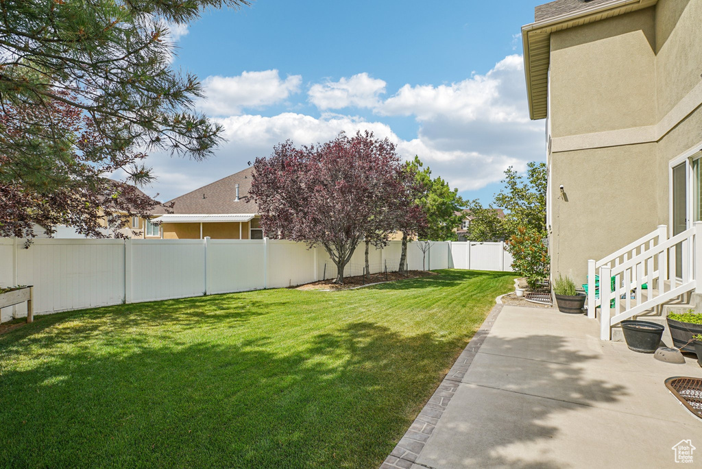 Fenced backyard with a patio area