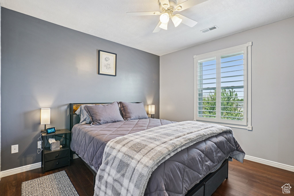 Bedroom with dark wood-style floors and ceiling fan