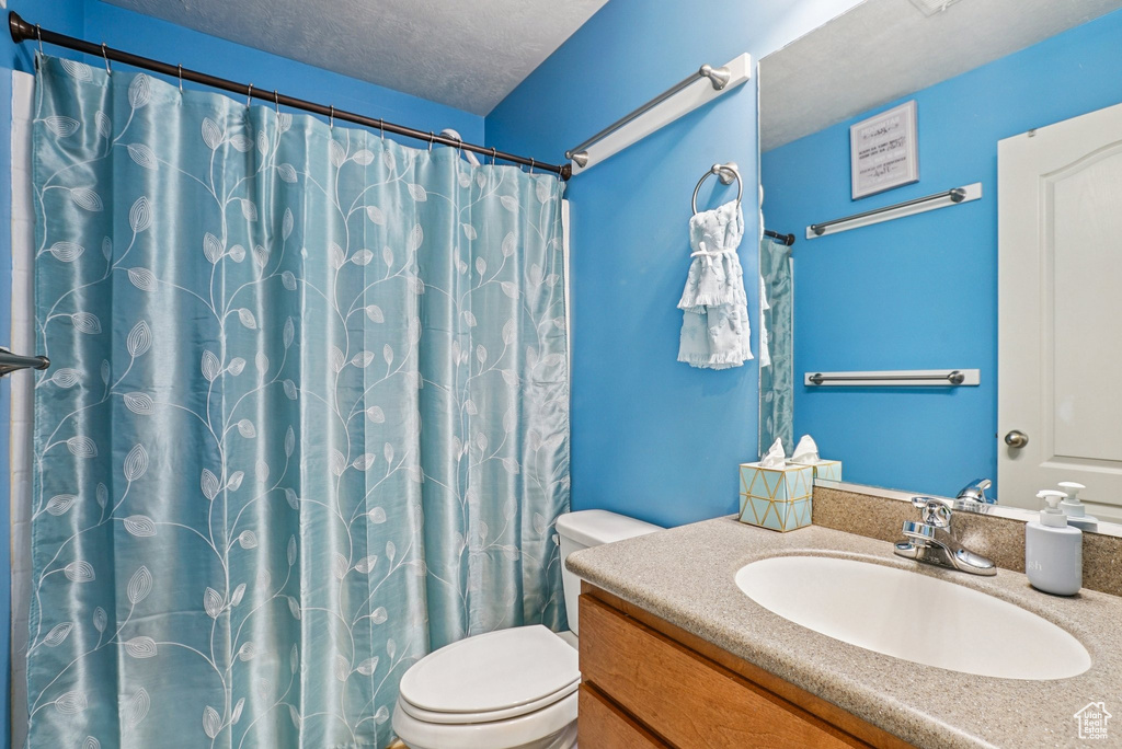 Full bathroom with vanity and a shower with curtain