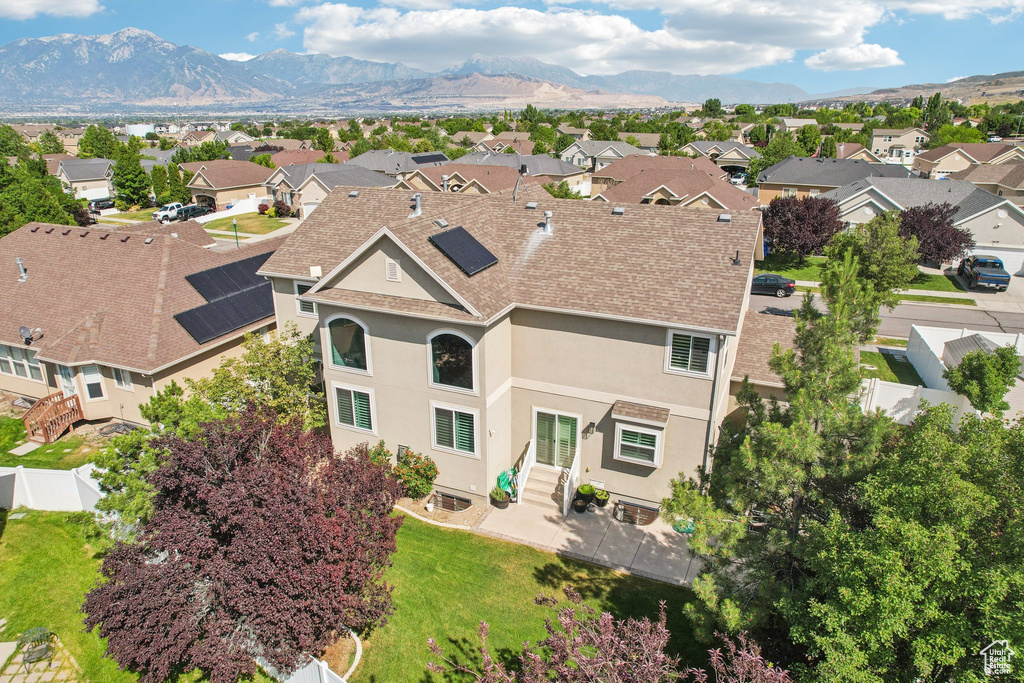 Aerial view of residential area featuring a mountainous background