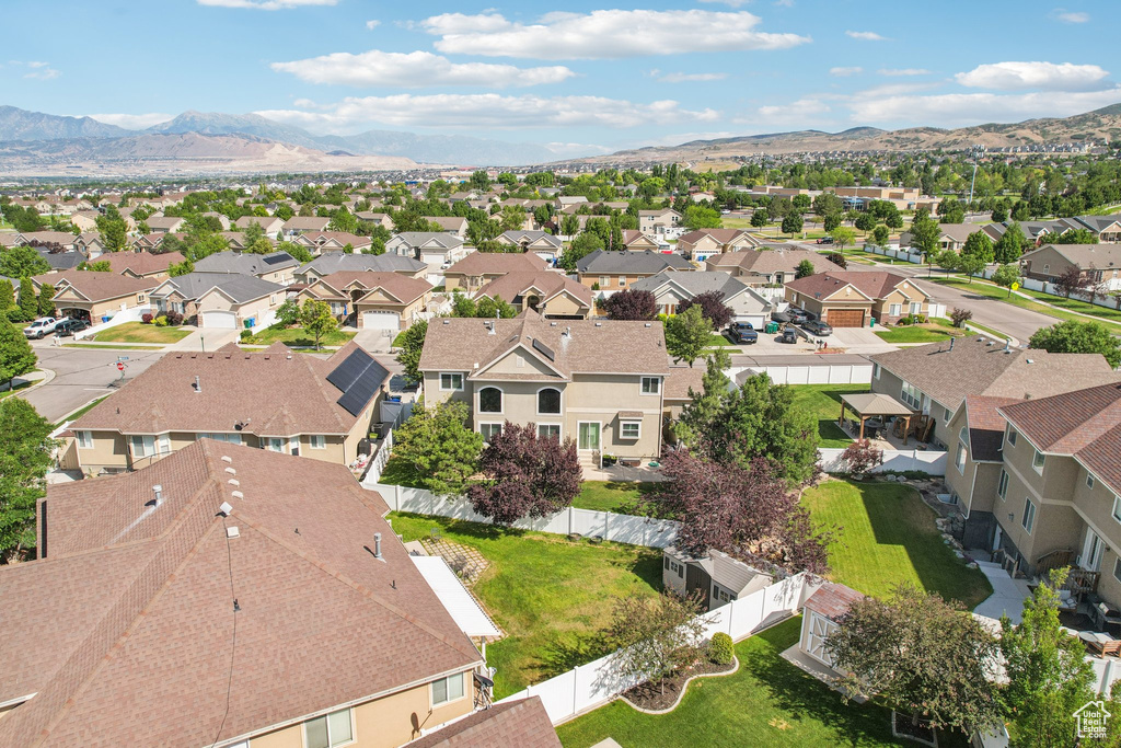 Aerial perspective of suburban area featuring a mountain backdrop