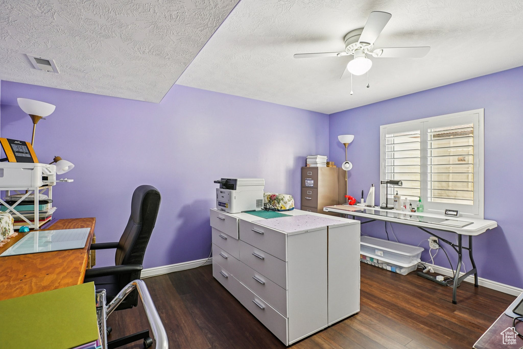 Office space with dark wood-style flooring, ceiling fan, and a textured ceiling