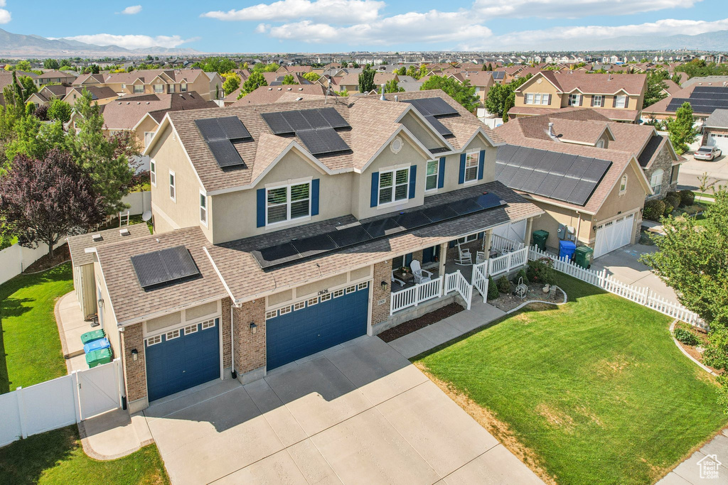 View of front of property with a residential view, driveway, roof with shingles, and a fenced backyard