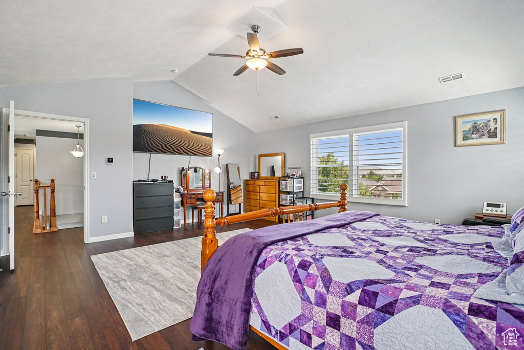 Bedroom with lofted ceiling, wood finished floors, and a ceiling fan