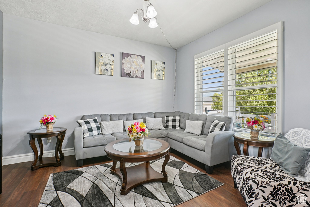 Living room with wood finished floors and a chandelier