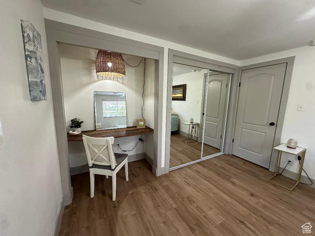 Home office with wood finished floors and baseboards