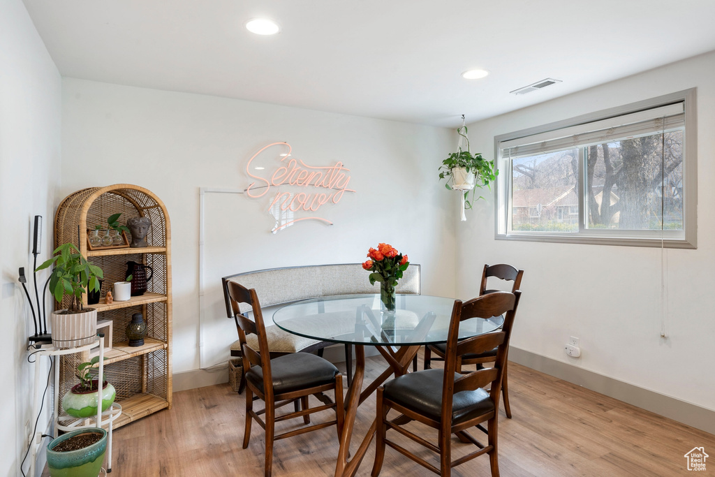 Dining area featuring light wood finished floors and recessed lighting