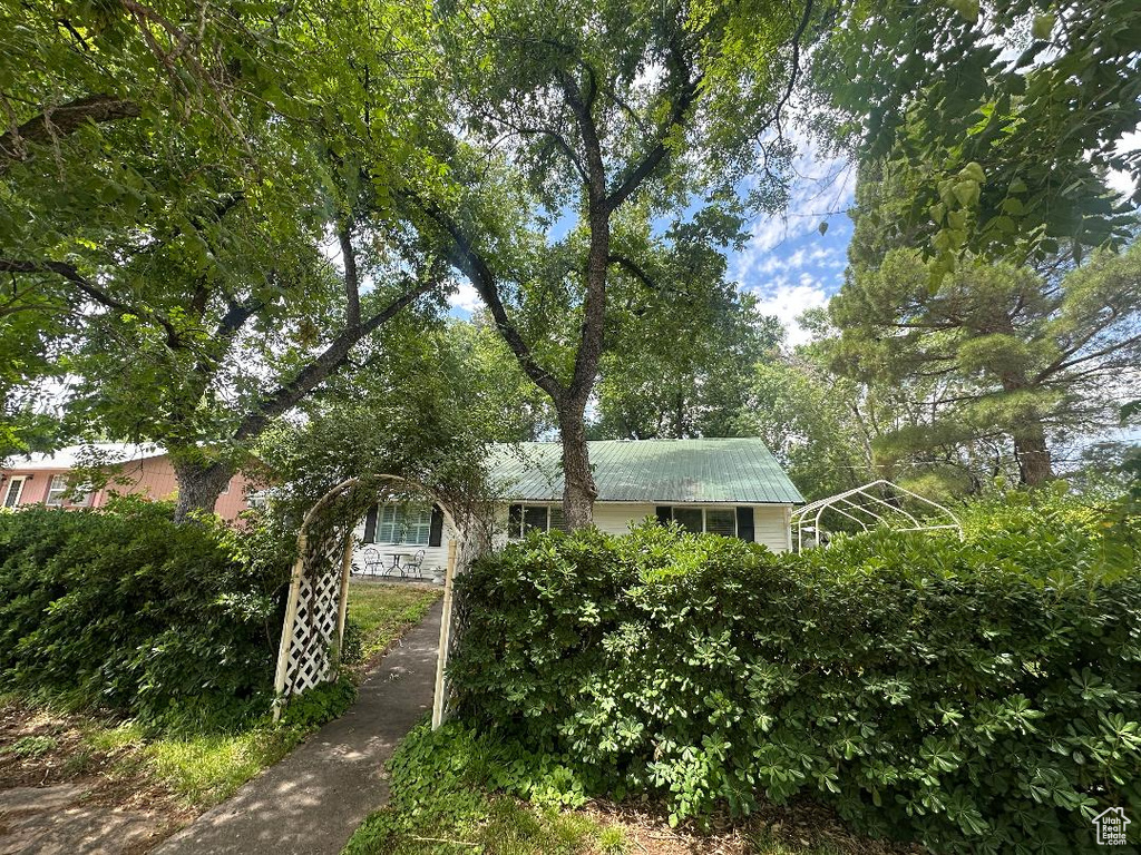 Obstructed view of property featuring a metal roof