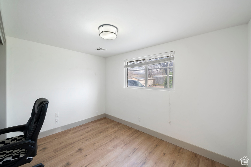 Unfurnished office featuring baseboards and light wood-type flooring