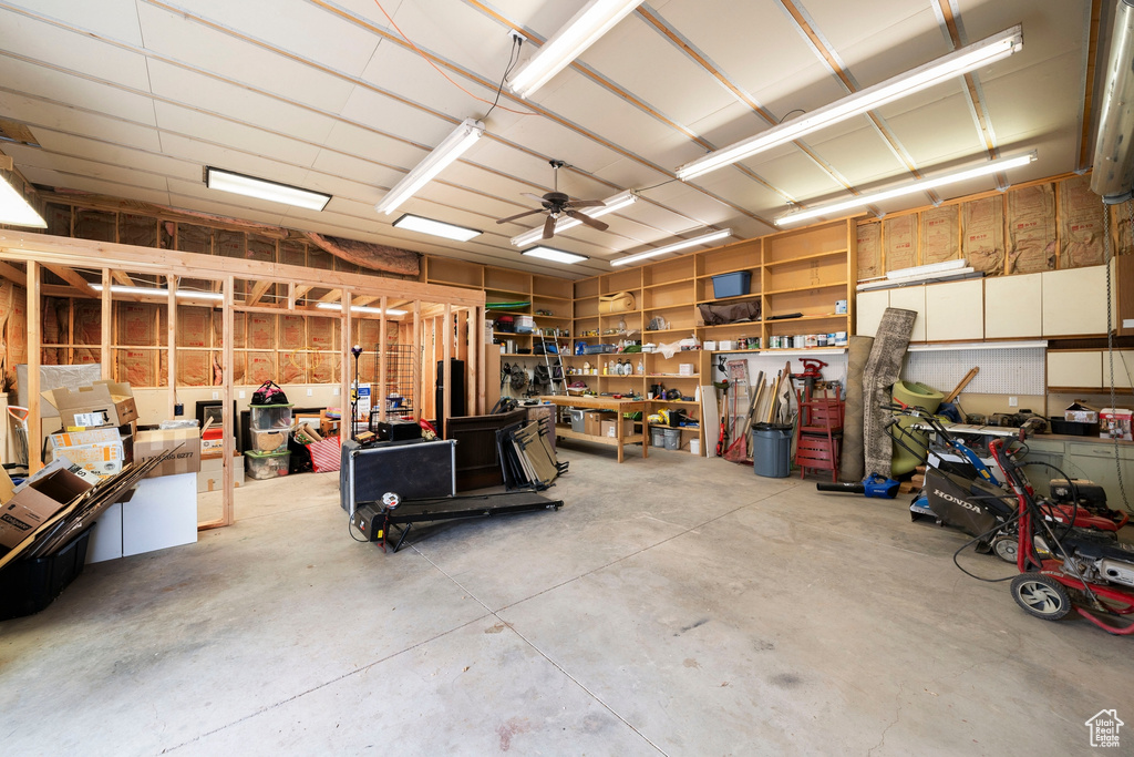 Garage with a workshop area and ceiling fan