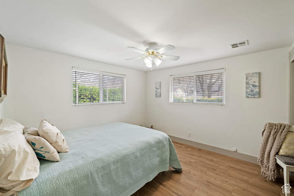 Bedroom with light wood-type flooring and a ceiling fan