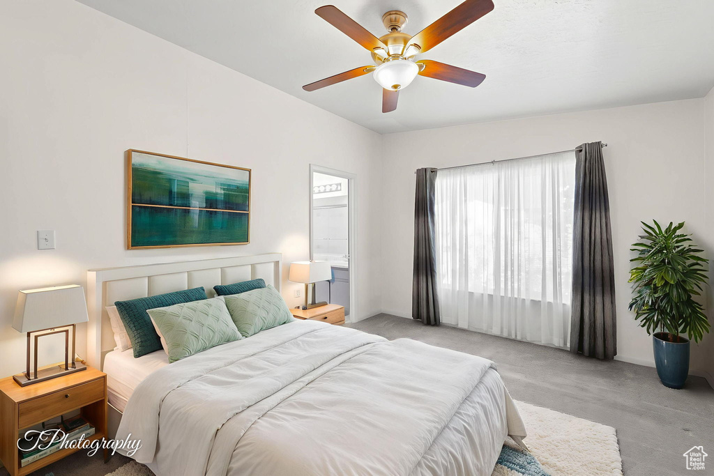 Bedroom with a ceiling fan and connected bathroom