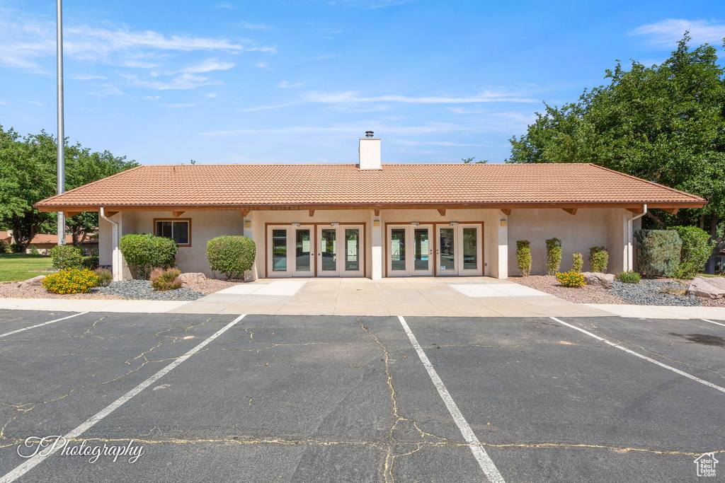 View of building exterior featuring uncovered parking