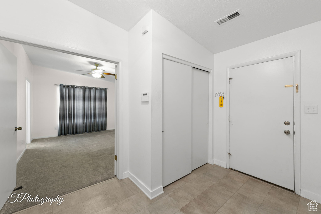 Entryway featuring ceiling fan and baseboards