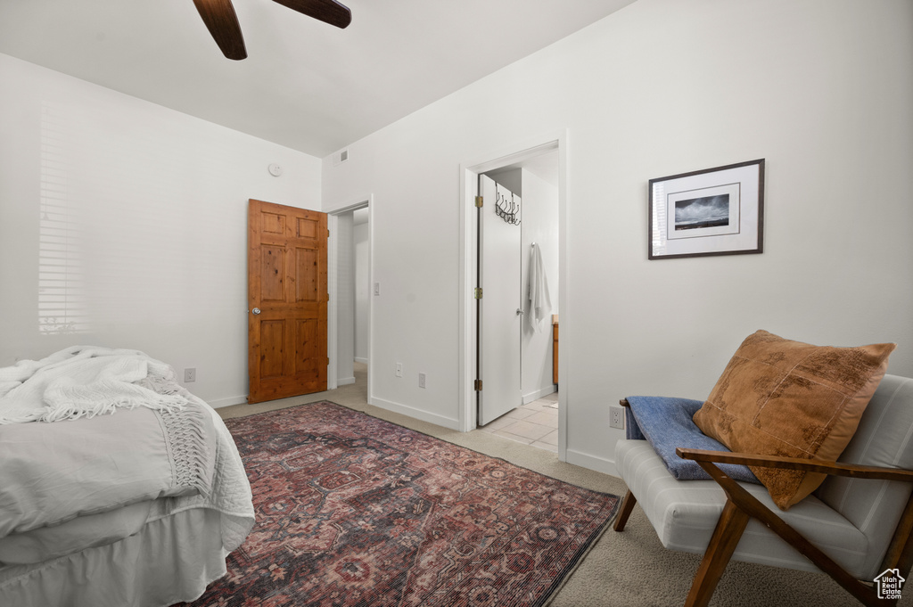 Bedroom with light colored carpet and a ceiling fan