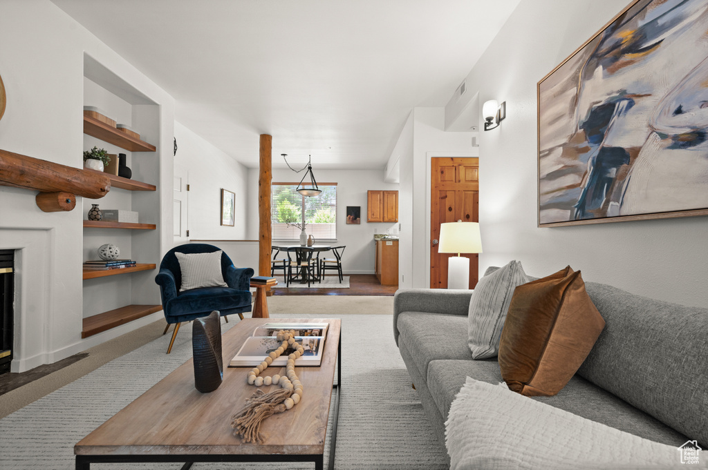 Living area with built in shelves and light colored carpet