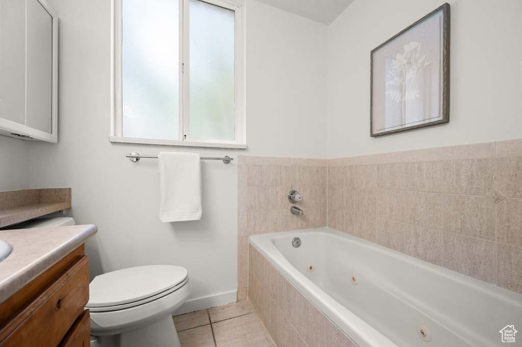Full bath with vanity, a tub with jets, and tile patterned floors