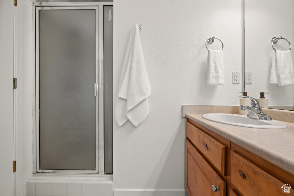 Bathroom with vanity and a stall shower
