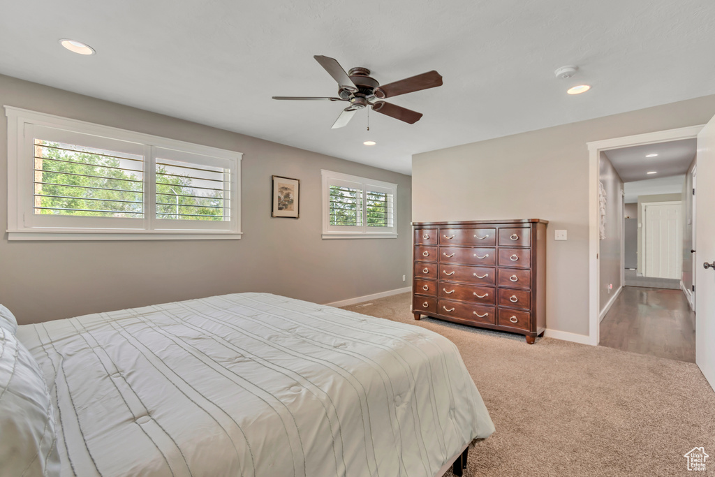 Carpeted bedroom with recessed lighting and a ceiling fan