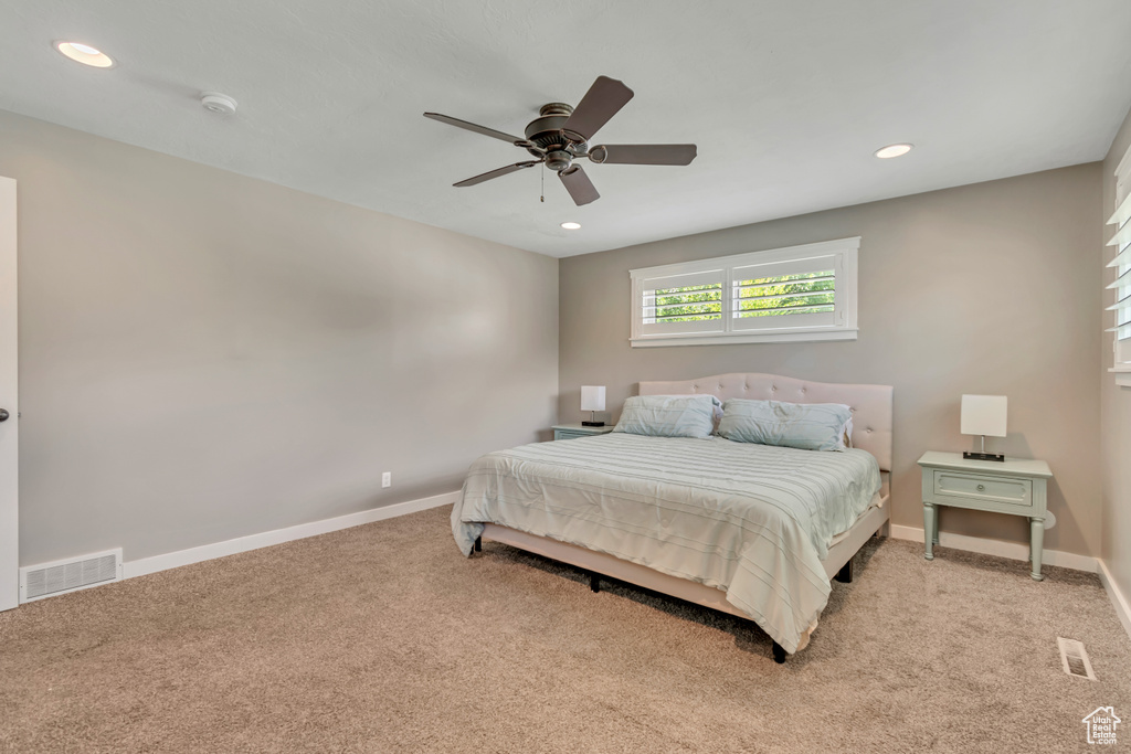 Bedroom featuring light carpet, recessed lighting, and ceiling fan