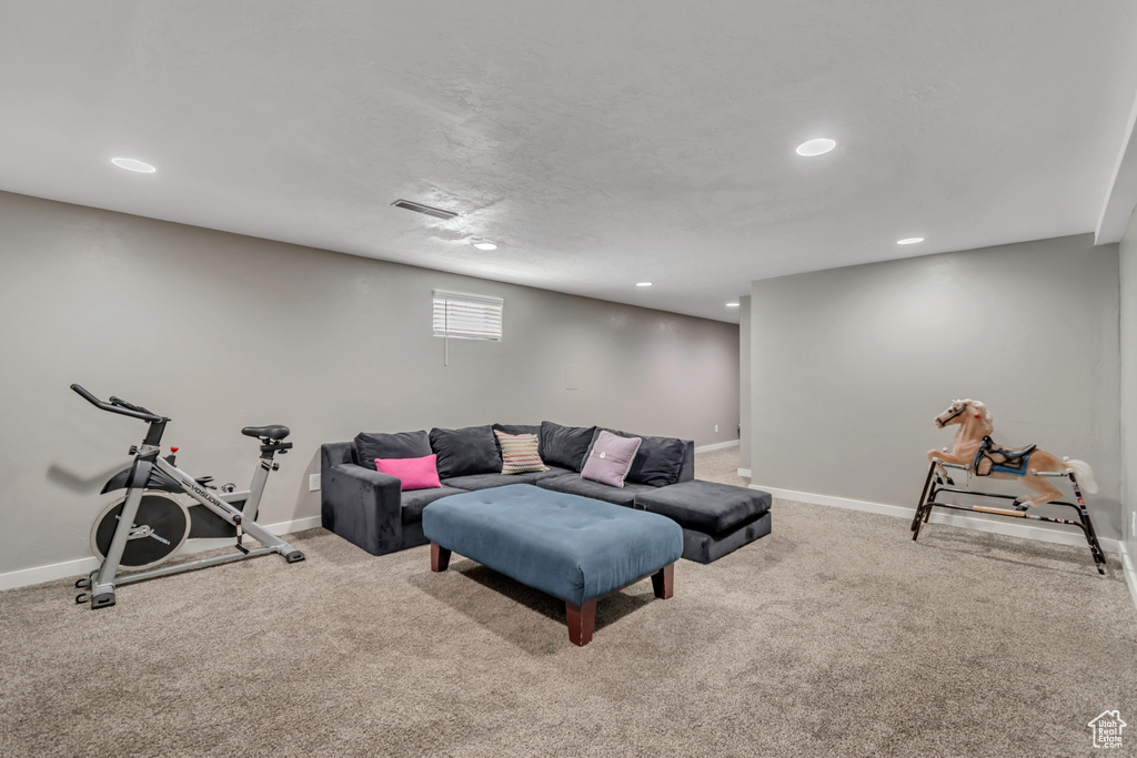 Living area with recessed lighting and carpet flooring
