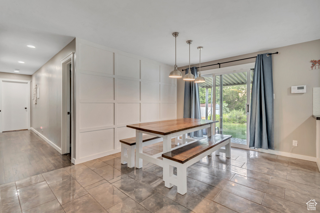 Dining space featuring a decorative wall and recessed lighting