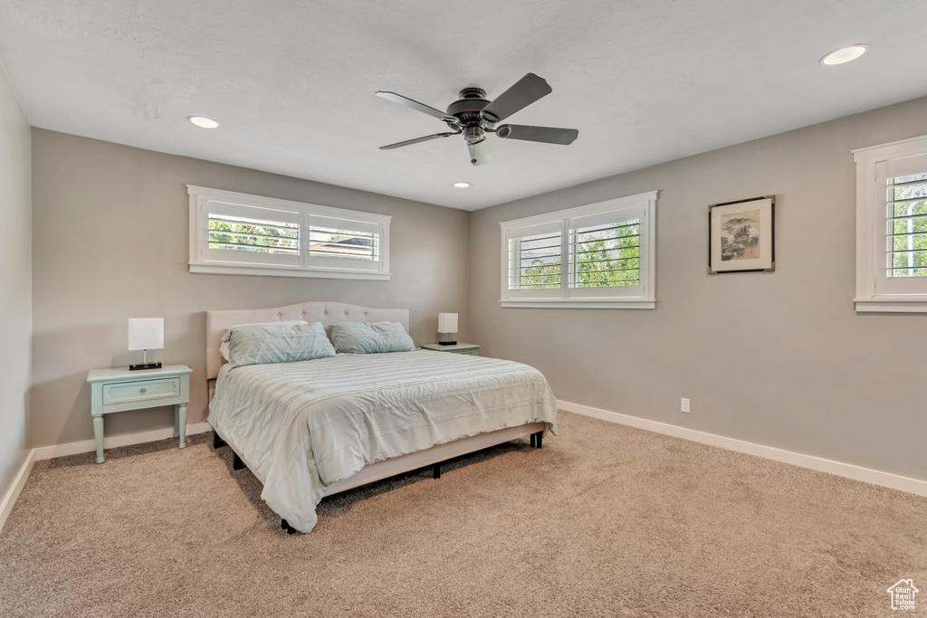 Carpeted bedroom with recessed lighting and ceiling fan