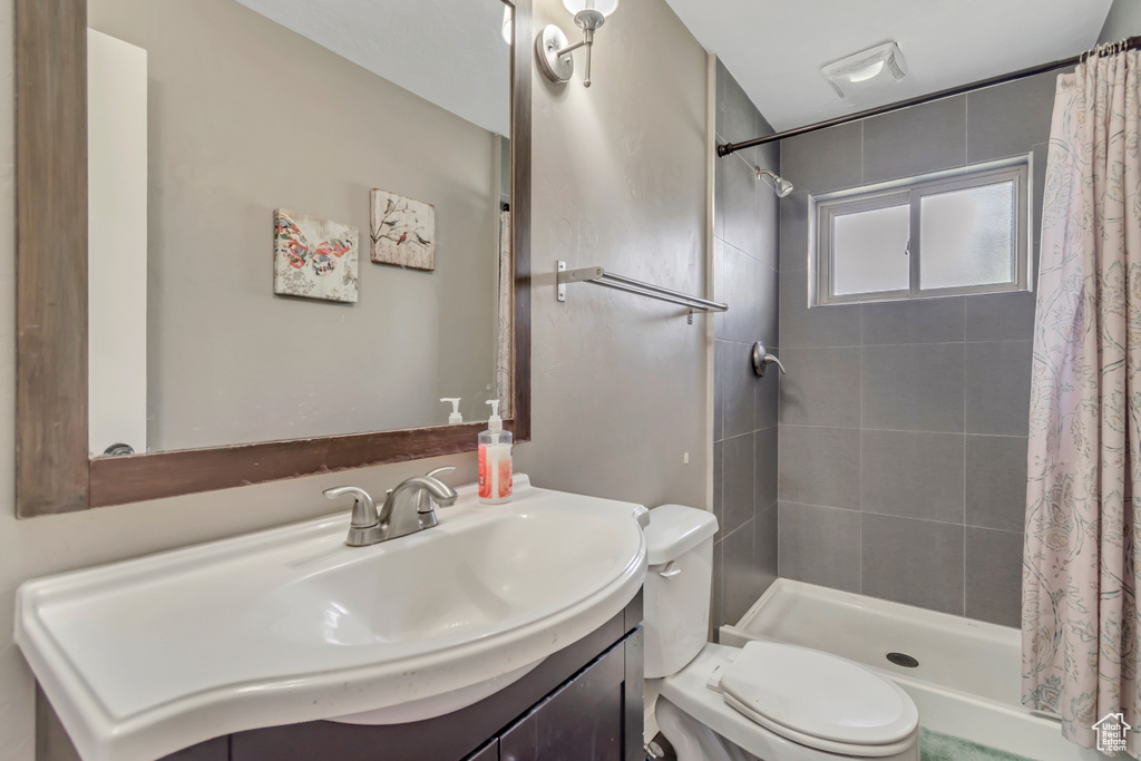 Bathroom featuring vanity and tiled shower