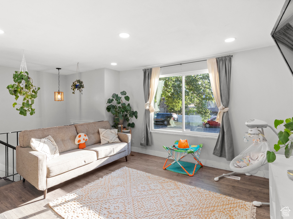 Living room with wood finished floors and recessed lighting