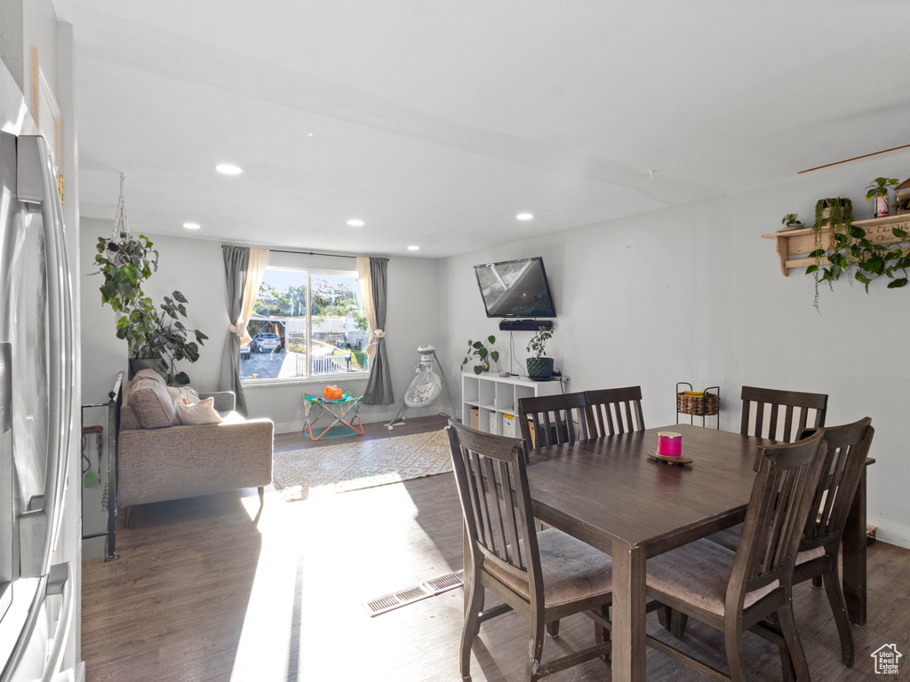 Dining area with wood finished floors and recessed lighting