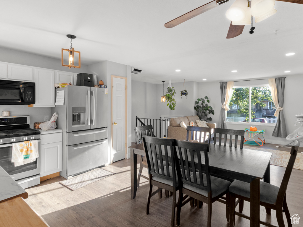 Dining space featuring light wood-type flooring, a chandelier, recessed lighting, and a ceiling fan