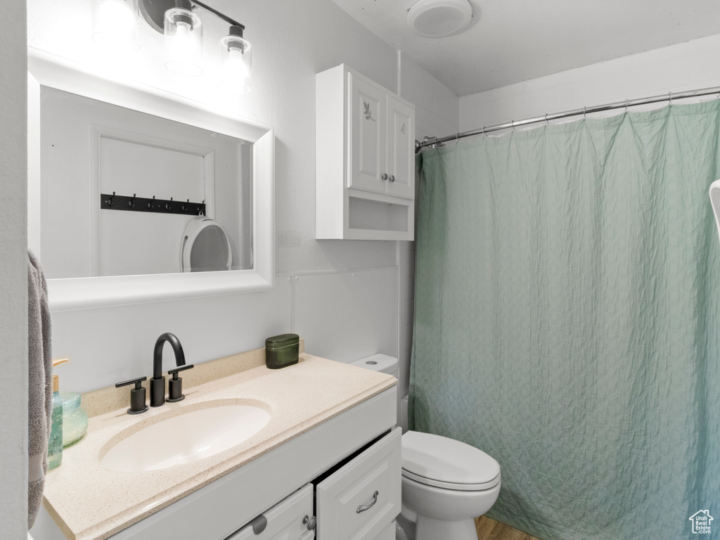 Full bathroom featuring vanity and curtained shower