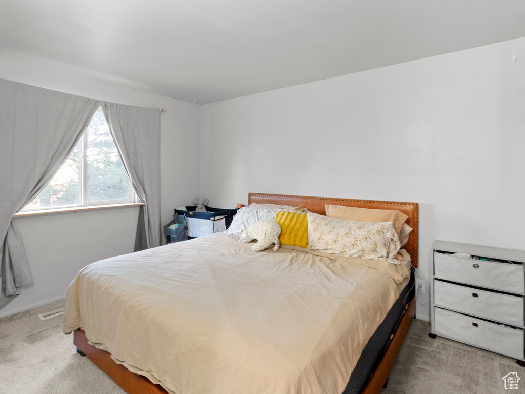 Carpeted bedroom featuring baseboards