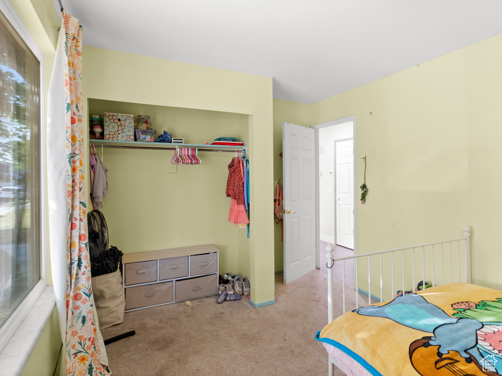 Carpeted bedroom with a closet