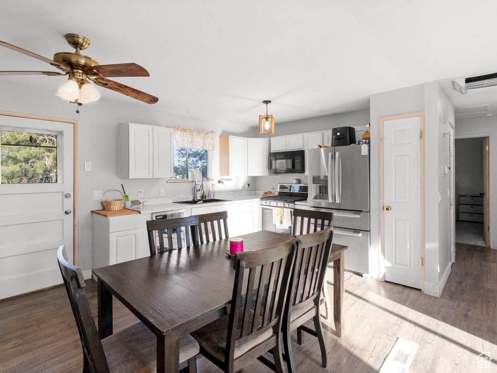 Dining area featuring light wood-style flooring and a ceiling fan