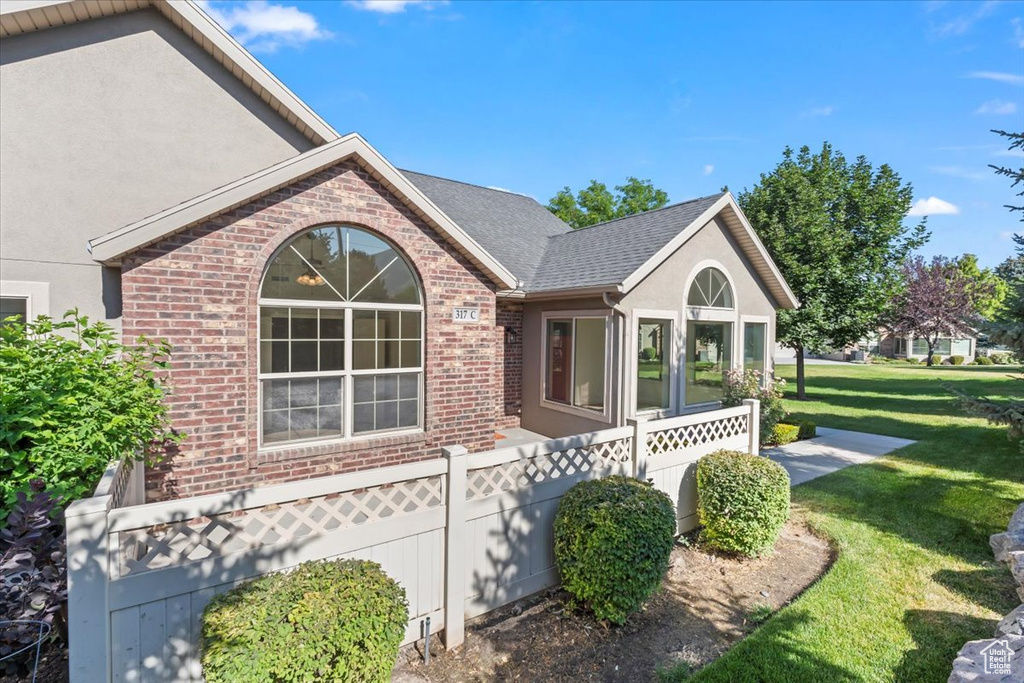 View of property exterior with brick siding and stucco siding