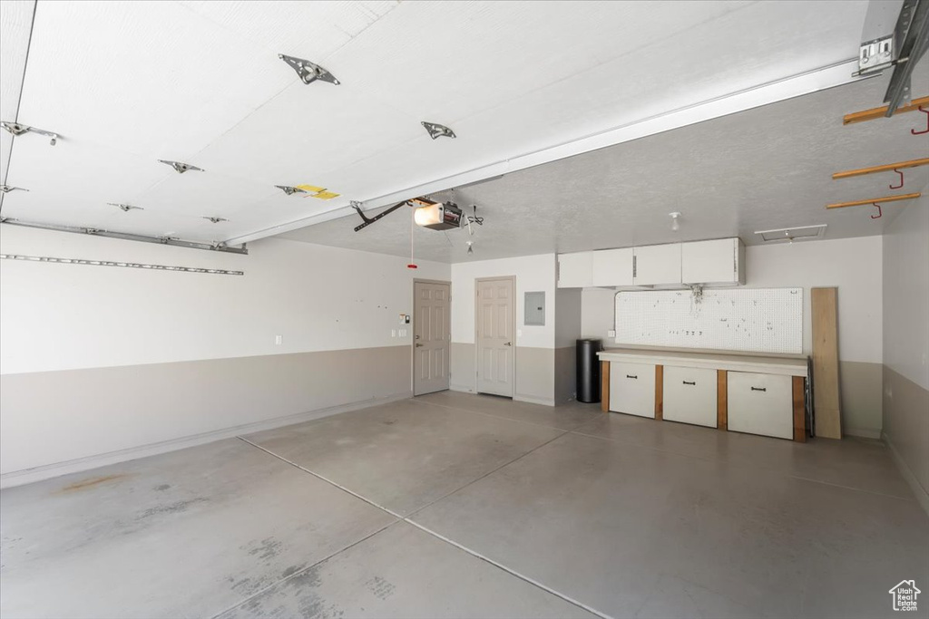 Garage with a garage door opener and electric panel