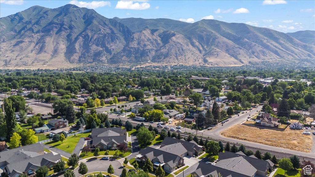 Aerial overview of property\'s location featuring nearby suburban area and a mountain backdrop