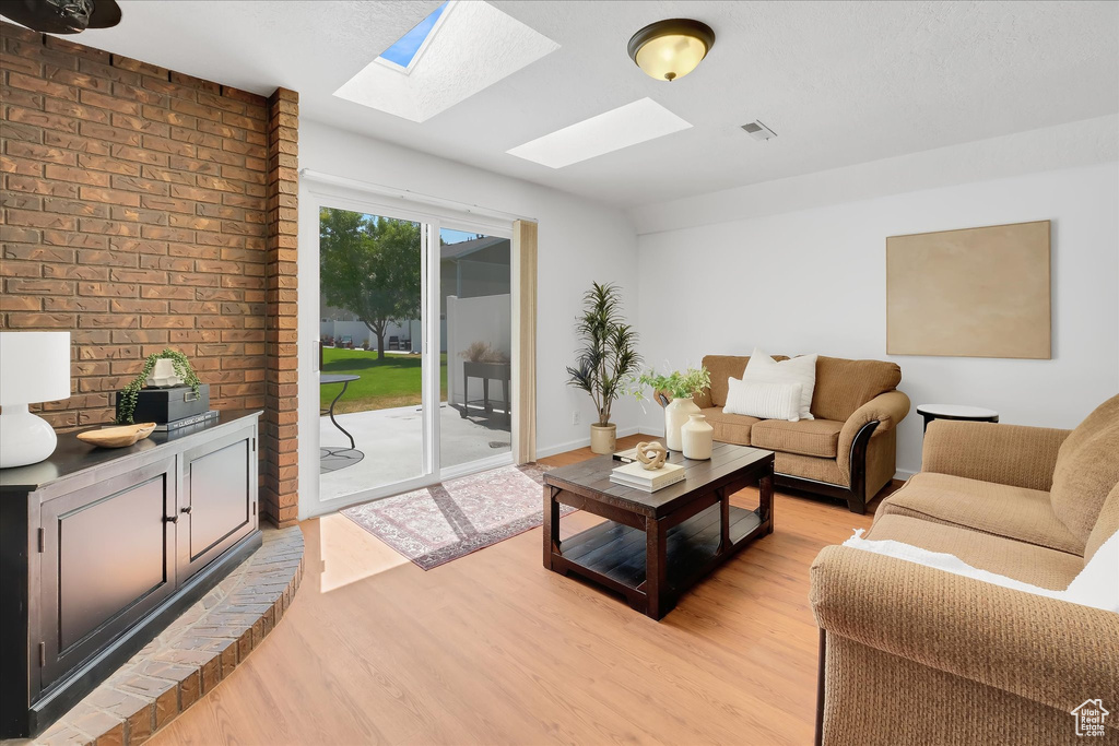 Living room featuring a skylight and light wood-style floors