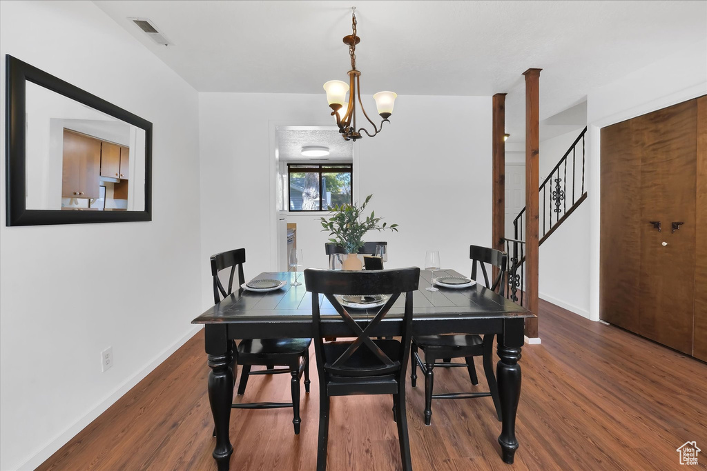 Dining room with wood finished floors and stairs