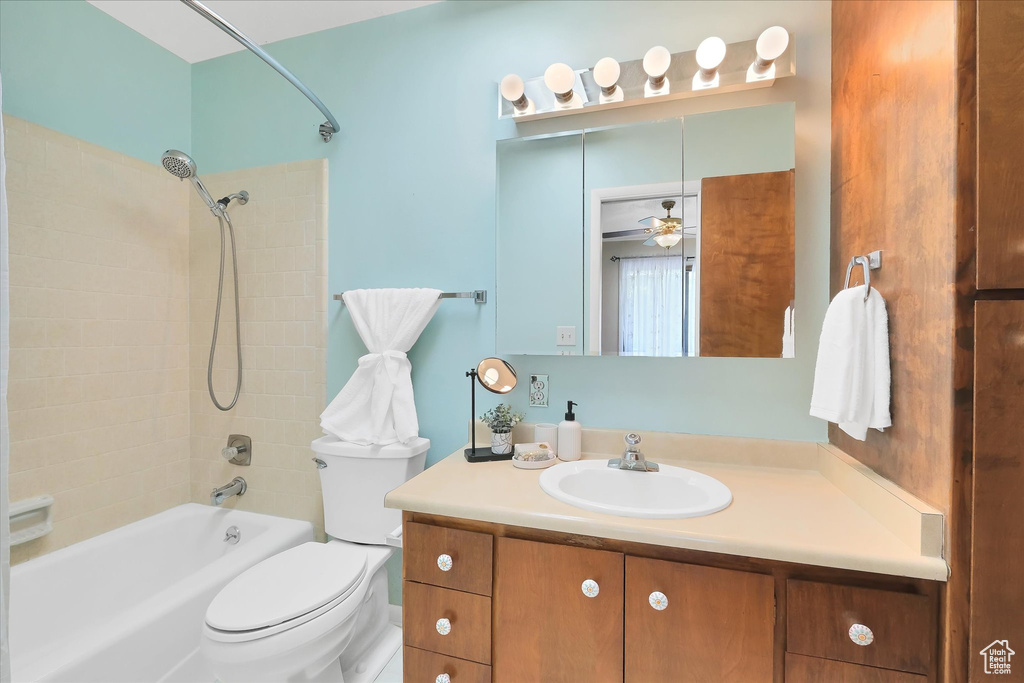Bathroom with shower / tub combination, vanity, and ceiling fan